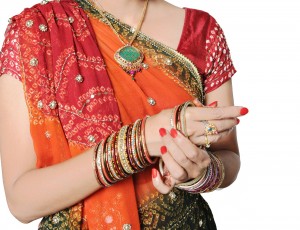 Traditional Indian Girl wearing bangles in her hand.